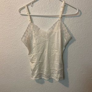 A lettuce trim silk top in white.IMPORTANT there is rip in the back of shirt